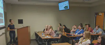 Students listening to research presentation